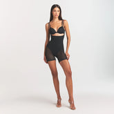 POWER MESH SHAPEWEAR CORE SCULPT OPEN BUST MID THIGH BODYSUIT | ONYX ON A MODEL FRONT VIEW @
