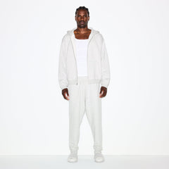 FLEECE LOUNGE MENS TAPERED JOGGER | LIGHT HEATHER GREY ON A MODEL FRONT VIEW @ | FOCUS: 0.0, 1.0, 0.9