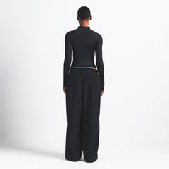 NikeSKIMS WOVEN NYLON OVERSIZED TRACK PANT | OBSIDIAN ON A MODEL BACK VIEW @ | FOCUS: 0.0, 1.0, 0.9
