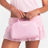 SKIMS ACCESSORIES SATIN MINI DUFFLE BAG | PEONY ON A MODEL FRONT VIEW @ | FOCUS: 0.0, 1.0, 0.9