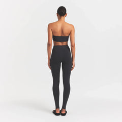OUTDOOR STIRRUP LEGGING | WASHED ONYX ON A MODEL BACKVIEW @ | FOCUS: 0.0, 1.0, 0.9