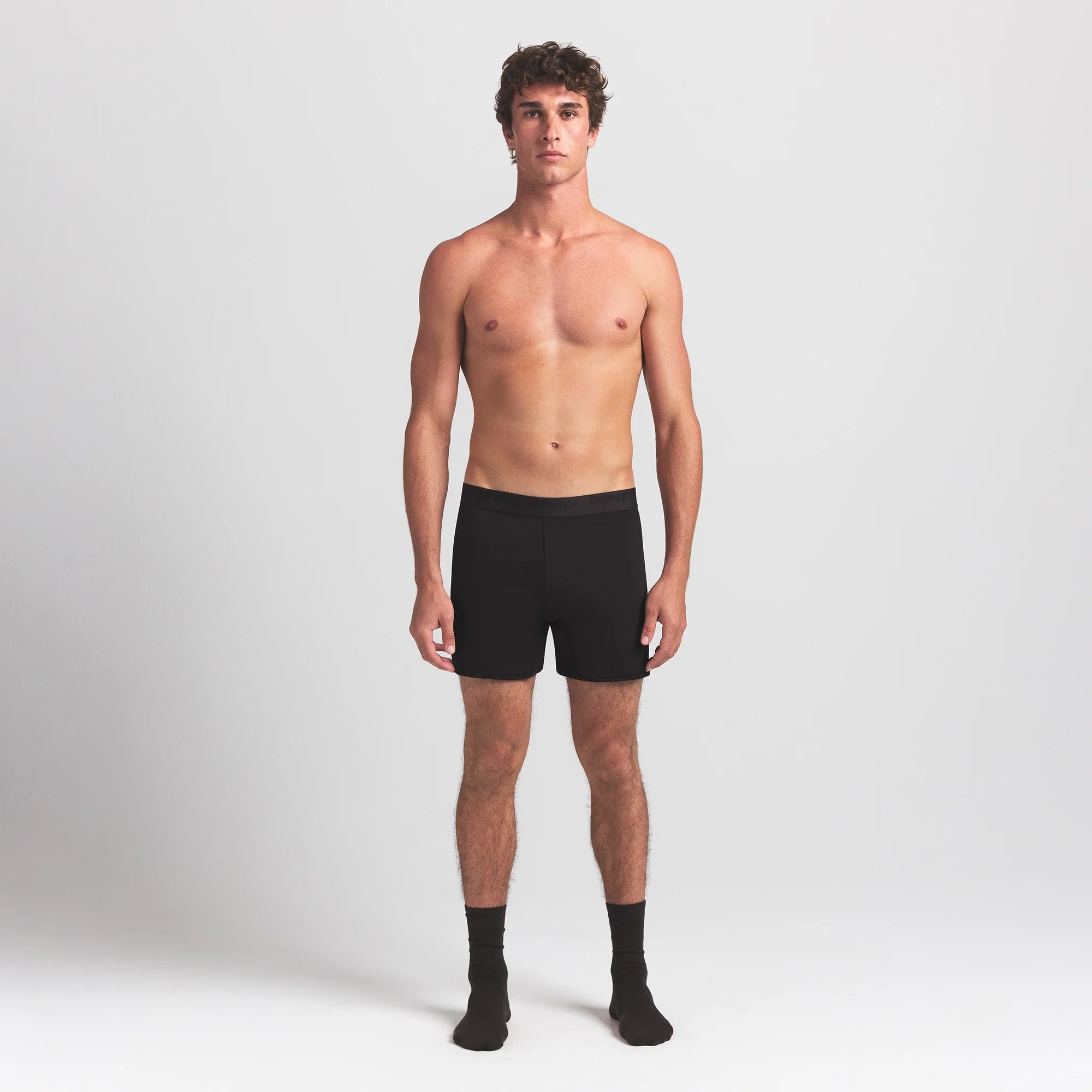 SKIMS STRETCH MENS KNIT BOXER | OBSIDIAN ON A MODEL FRONT VIEW @ | FOCUS: 0.0, 1.0, 0.9