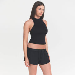 NikeSKIMS MATTE MOCK NECK RACER TANK | OBSIDIAN ON A MODEL FRONT VIEW @ | FOCUS: 0.9, 0.1, 0.7