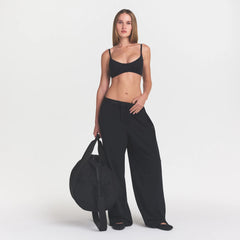 NikeSKIMS MATTE MICRO SCOOP BRA | OBSIDIAN ON A MODEL FRONT VIEW @ | FOCUS: 0.9, 0.1, 0.7