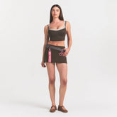 NikeSKIMS MATTE SKORT | NSKM DARK SEPIA ON A MODEL