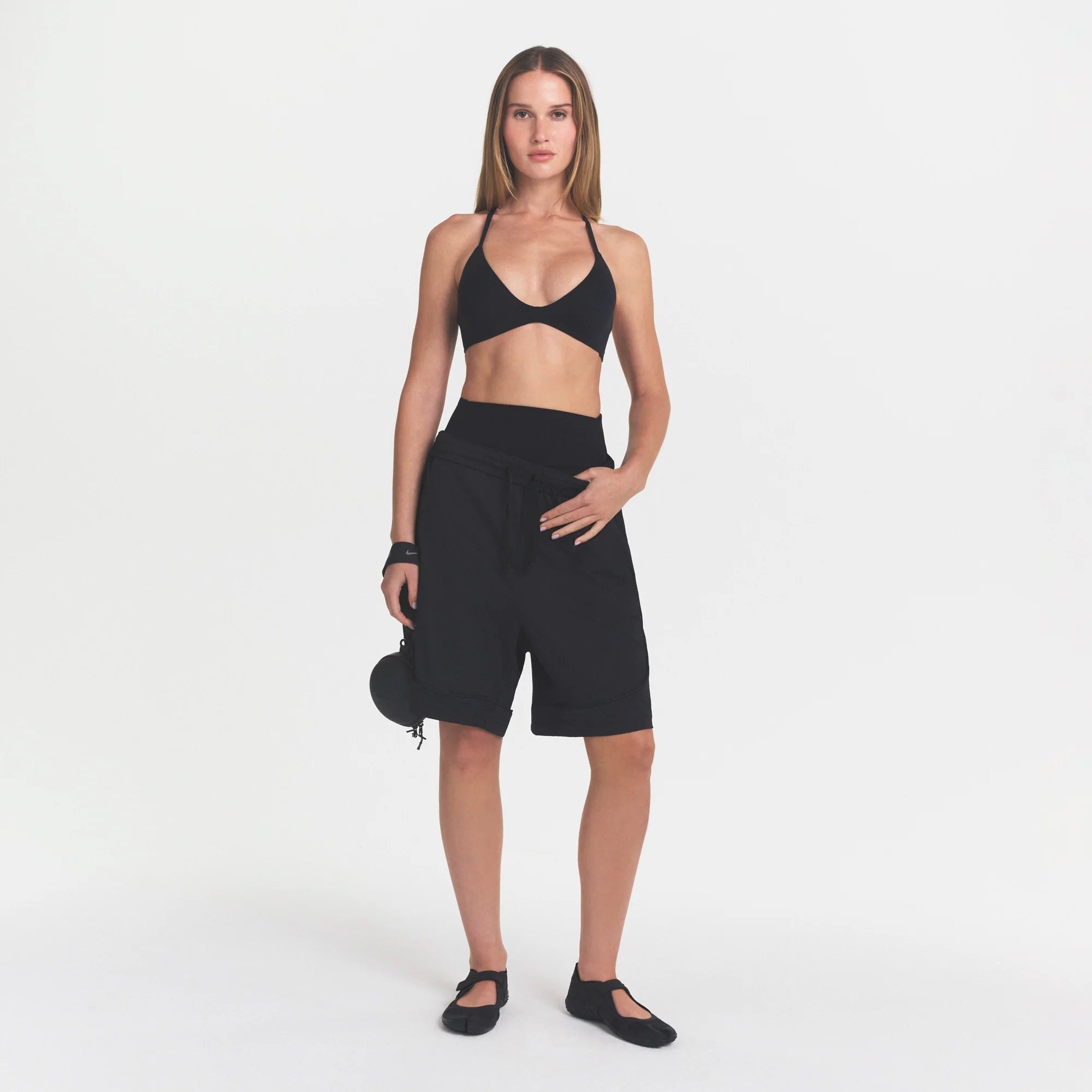 NikeSKIMS STUDIO STRETCH T-BACK TRIANGLE BRA | OBSIDIANON A MODEL FRONT