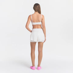 NikeSKIMS STRETCH NYLON RUNNER SHORT | IVORY ON A MODEL