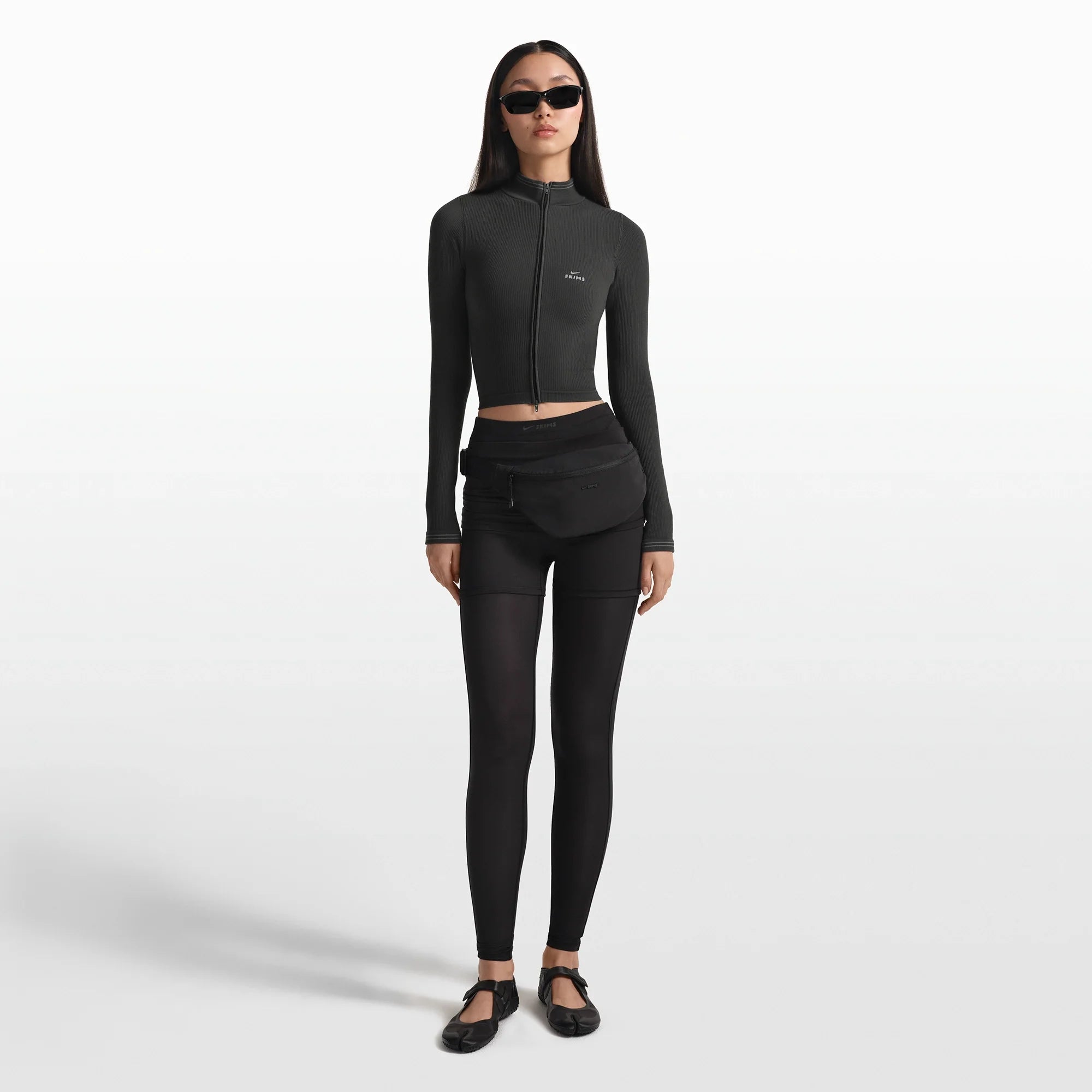 NikeSKIMS ACCESSORIES FANNY PACK | OBSIDIAN ON A MODEL FRONT VIEW @ | FOCUS: 0.0, 1.0, 0.9