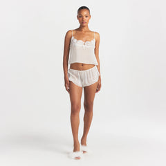 SKIMS ROMANCE CAMI AND SHORT SET | IVORY ON A MODEL FRONT VIEW @ | FOCUS: 0.0, 1.0, 0.9