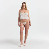 SKIMS ROMANCE BABYDOLL TOP AND STRING THONG SET | IVORY ON A MODEL FRONT VIEW @ | FOCUS: 0.0, 1.0, 0.9