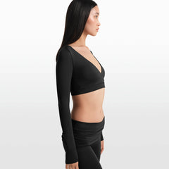NikeSKIMS MATTE WRAP LONG SLEEVE CROPPED TOP | OBSIDIAN ON A MODEL FRONT VIEW @ | FOCUS: 0.0, 1.0, 0.9