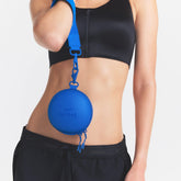 NikeSKIMS ACCESSORIES HARDSHELL ROUND CASE | COBALT ON A MODEL SIDE VIEW @ | FOCUS: 0.0, 1.0, 0.9