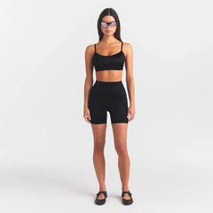 NikeSKIMS SATIN SHINE BONDED WAIST 5" BIKER SHORT | OBSIDIAN ON A MODEL FRONT VIEW