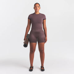 NikeSKIMS SATIN SHINE BONDED WAIST 5" BIKER SHORT | RESIN ON A MODEL FRONT VIEW