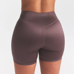 NikeSKIMS SATIN SHINE BONDED WAIST 5" BIKER SHORT | RESIN ON A MODEL SIDE VIEW