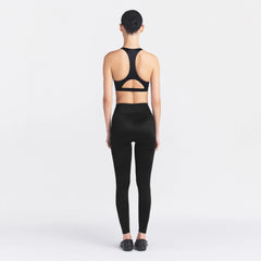 NikeSKIMS SATIN SHINE BONDED WAIST 26" LEGGING | OBSIDIAN ON A MODEL FRONT VIEW