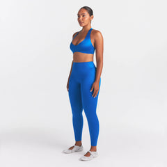 NikeSKIMS SATIN SHINE BONDED WAIST LEGGING 26" | COBALT ON A MODEL FRONT VIEW