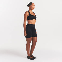 NikeSKIMS SATIN SHINE BONDED WAIST 7" BIKER SHORT | OBSIDIAN ON A MODEL FRONT VIEW