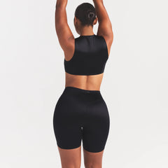 NikeSKIMS SATIN SHINE BONDED WAIST 7" BIKER SHORT | OBSIDIAN ON A MODEL SIDE VIEW
