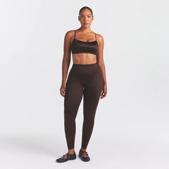 NikeSKIMS SATIN SHINE BONDED WAIST LEGGING 29" | PHOENIX ON A MODEL FRONT VIEW