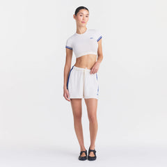 NikeSKIMS STRETCH KNIT DOLPHIN SHORT | IVORY ON A MODEL FRONT VIEW @ | FOCUS: 0.0, 1.0, 0.9