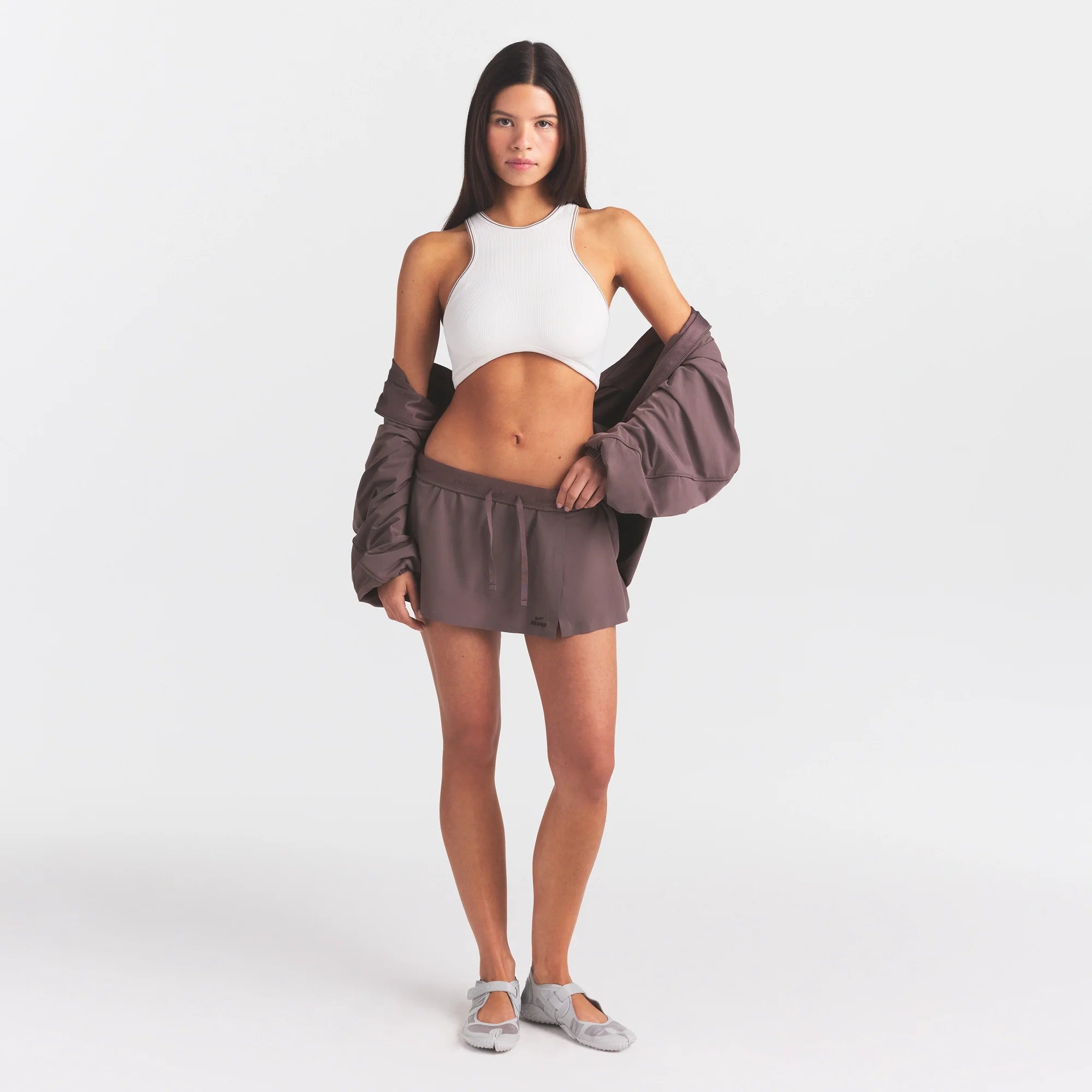 NikeSKIMS STRETCH NYLON SKORT | RESIN ON A MODEL FRONT VIEW @ | FOCUS: 0.0, 1.0, 0.9