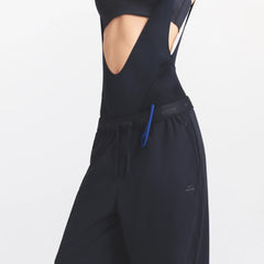 NikeSKIMS STRETCH NYLON OVERSIZED PANT | OBSIDIAN ON A MODEL SIDE VIEW