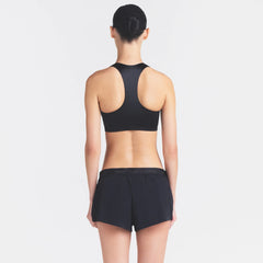 NikeSKIMS STRETCH NYLON RUNNER SHORT | OBSIDIAN ON A MODEL SIDE VIEW