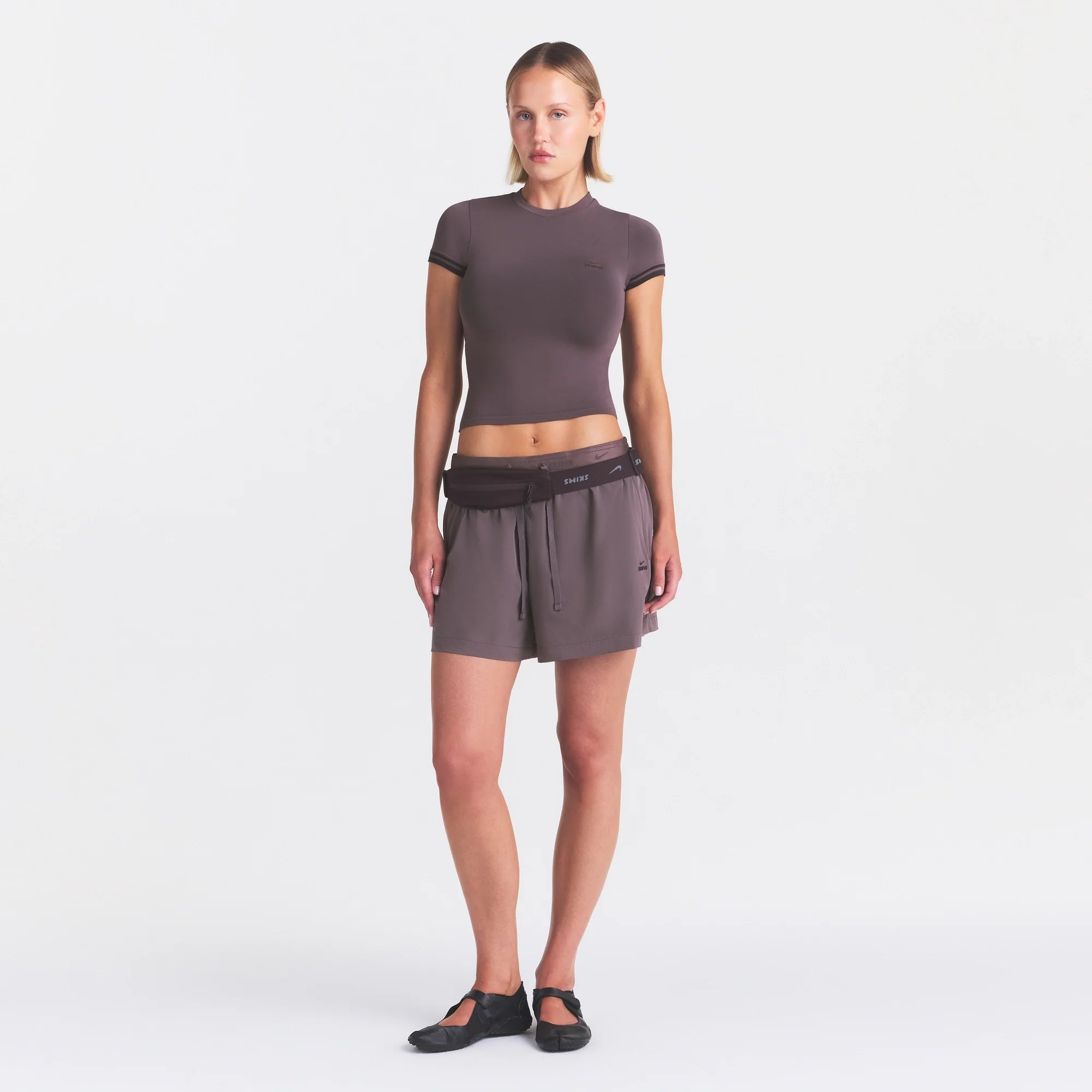 NikeSKIMS STRETCH NYLON 5" TRACK SHORT | RESIN ON A MODEL FRONT VIEW