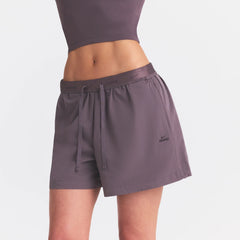 NikeSKIMS STRETCH NYLON 5" TRACK SHORT | RESIN ON A MODEL SIDE VIEW