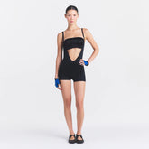 NikeSKIMS SATIN SHINE SUSPENDER 2.5" ONESIE | OBSIDIAN ON A MODEL FRONT VIEW