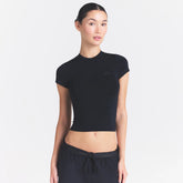 NikeSKIMS STRETCH KNIT CROPPED T-SHIRT | OBSIDIAN ON A MODEL SIDE VIEW @ | FOCUS: 0.0, 1.0, 0.9