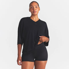 NikeSKIMS STRETCH KNIT OVERSIZED V-NECK TOP | OBSIDIAN ON A MODEL SIDE VIEW @ | FOCUS: 0.0, 1.0, 0.9