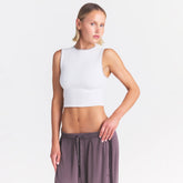 NikeSKIMS RIBBED SEAMLESS MUSCLE TANK | IVORY ON A MODEL SIDE VIEW @ | FOCUS: 0.0, 1.0, 0.9