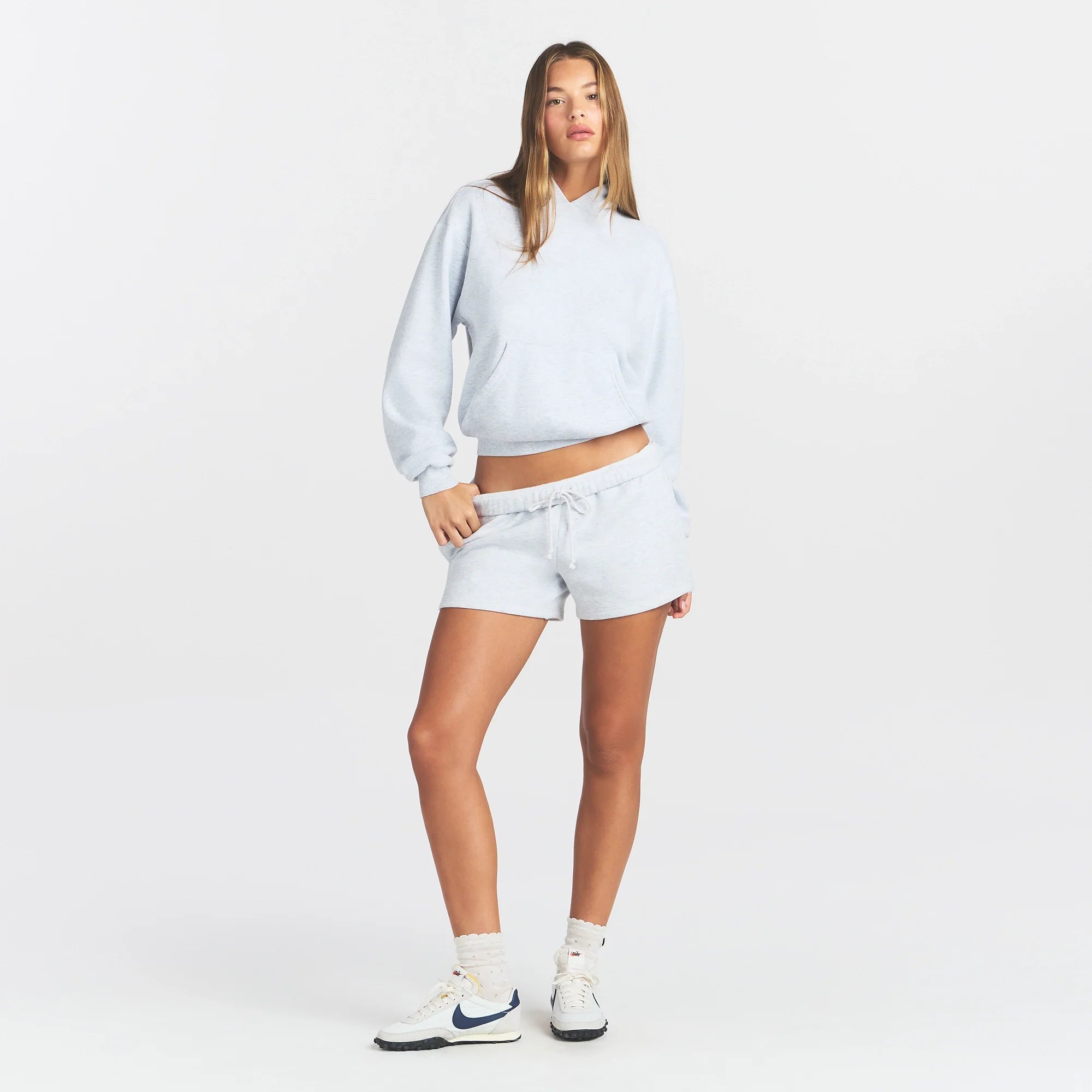 COTTON FLEECE CLASSIC HOODIE | LIGHT HEATHER GREY ON A MODEL FRONT VIEW @ | FOCUS: 0.0, 1.0, 0.9