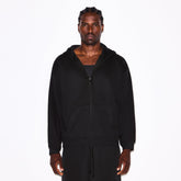 FLEECE LOUNGE MENS RELAXED ZIP UP HOODIE | WASHED ONYX ON A MODEL SIDE VIEW @ | FOCUS: 0.0, 1.0, 0.9
