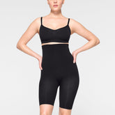 SEAMLESS SCULPT HIGH-WAISTED ABOVE THE KNEE SHORT WORN BY A MODEL IN FRONT VIEW
