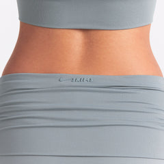 NikeSKIMS AIRY FOLDOVER SKORT | WASHED PACIFIC ON A MODEL SIDE VIEW @ | FOCUS: 0.0, 1.0, 0.9