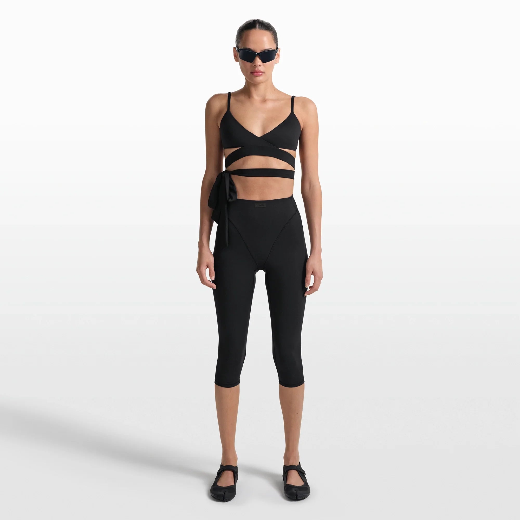 NikeSKIMS MATTE WRAP FRONT BRA | OBSIDIAN ON A MODEL FRONT VIEW @ | FOCUS: 0.0, 1.0, 0.9