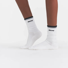 RIBBED CREW LOGO SOCK | SNOW AND ONYX ON A MODEL | FOCUS: 0.0, 1.0, 0.9