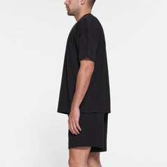 JERSEY LOUNGE MENS RELAXED T-SHIRT | OBSIDIAN ON A MODEL SIDE VIEW