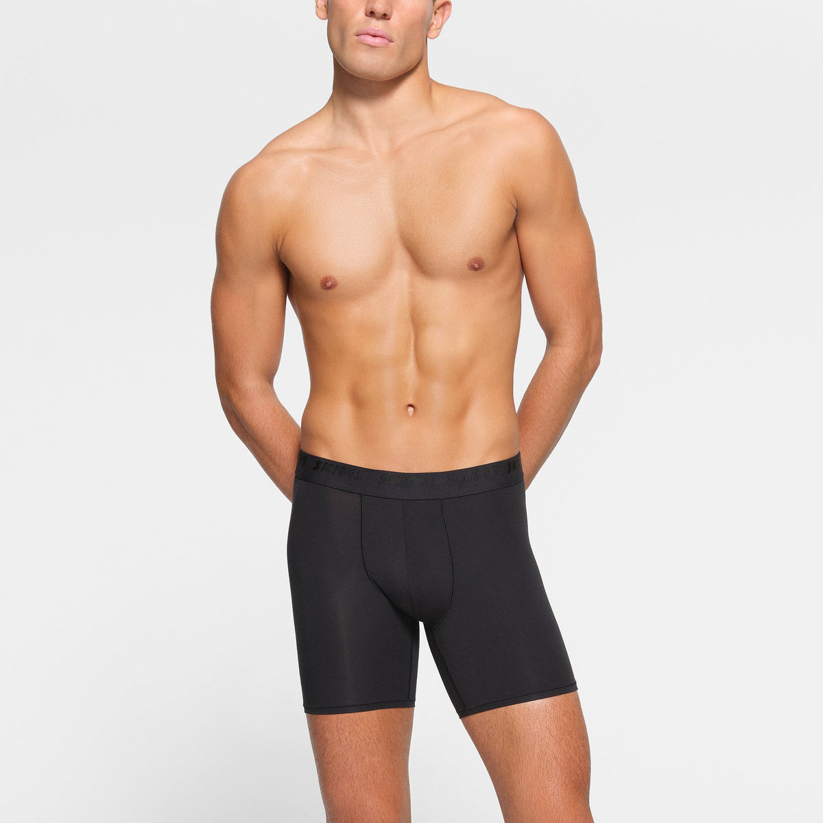 SKIMS STRETCH MENS 5" BOXER BRIEF 3-PACK WORN BY A MODEL IN FRONT VIEW