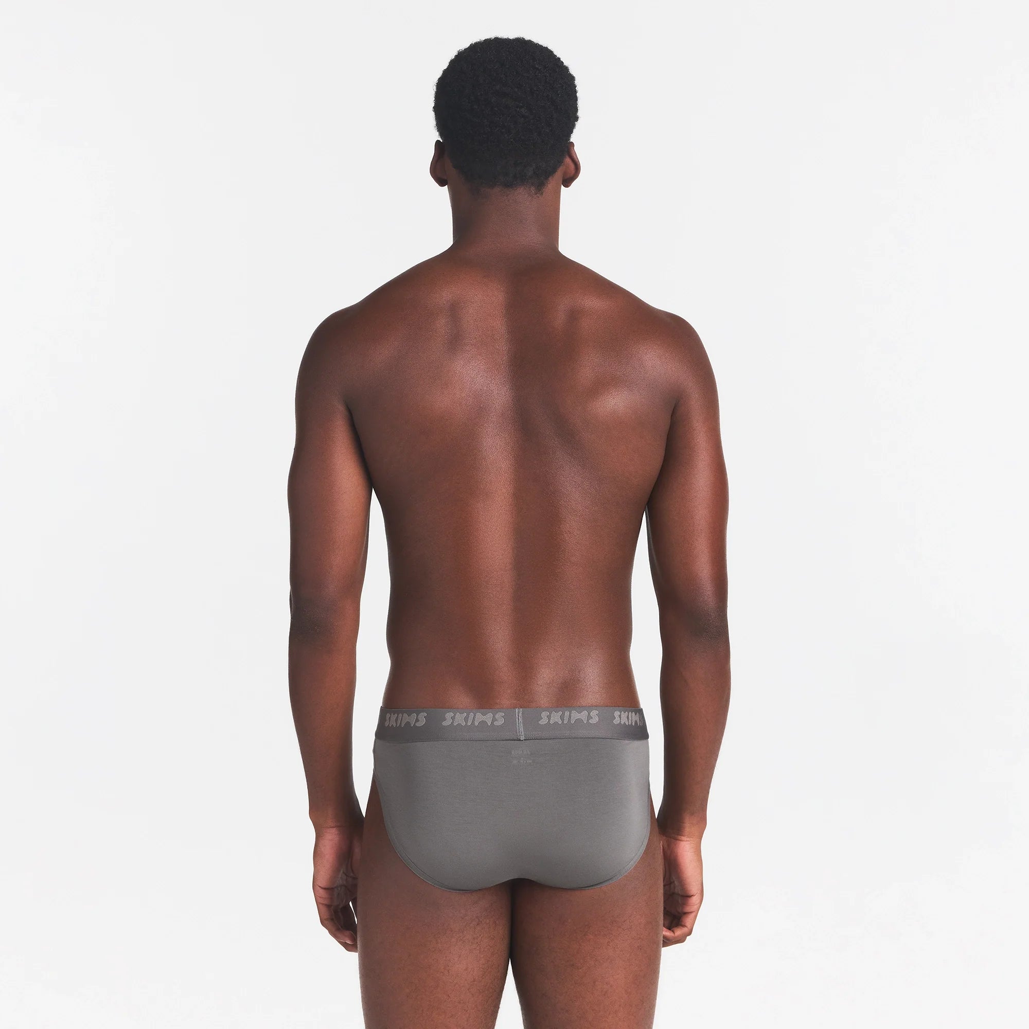 SKIMS STRETCH MENS BRIEF | GUNMETAL ON A MODEL BACK VIEW