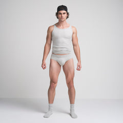 SKIMS COTTON MENS BRIEF | LIGHT HEATHER GREY ON A MODEL FRONT VIEW @ | FOCUS: 0.9, 0.1, 0.7