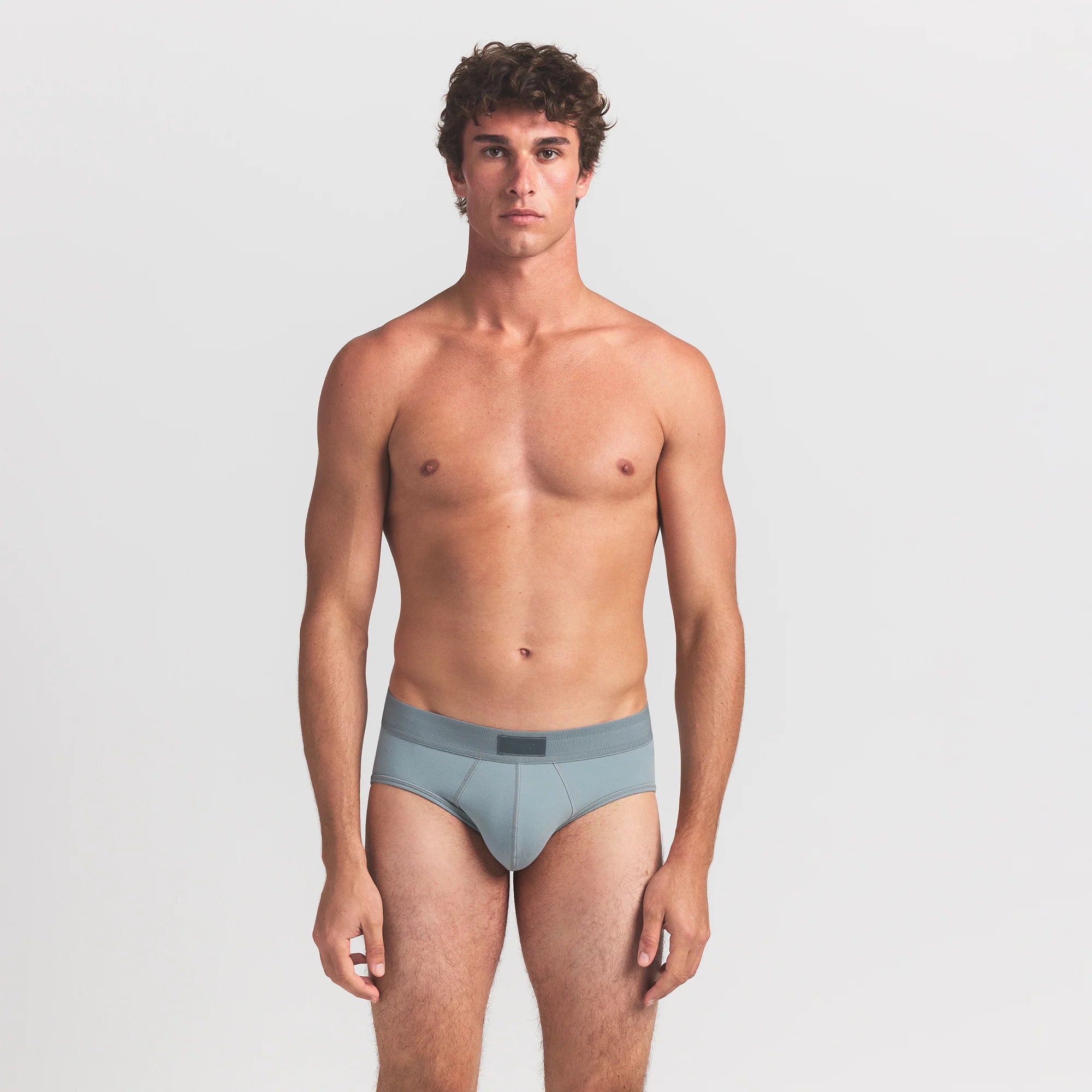 SKIMS COTTON MENS BRIEF 3-PACK | VERDANT MULTI ON A MODEL FRONT VIEW @ | FOCUS: 0.0, 1.0, 0.9