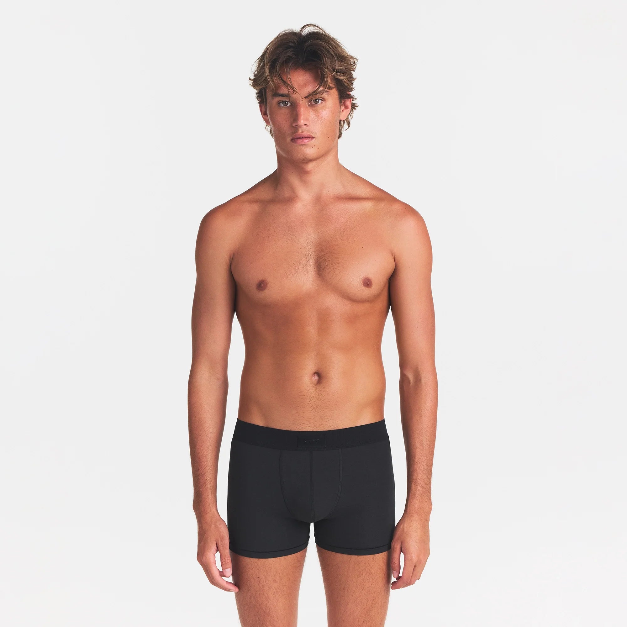SKIMS COTTON MENS 3" BOXER BRIEF | ONYX ON A MODEL FRONT VIEW
