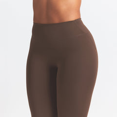 NikeSKIMS MATTE 26" LEGGING | DARK SEPIA ON A MODEL SIDE VIEW