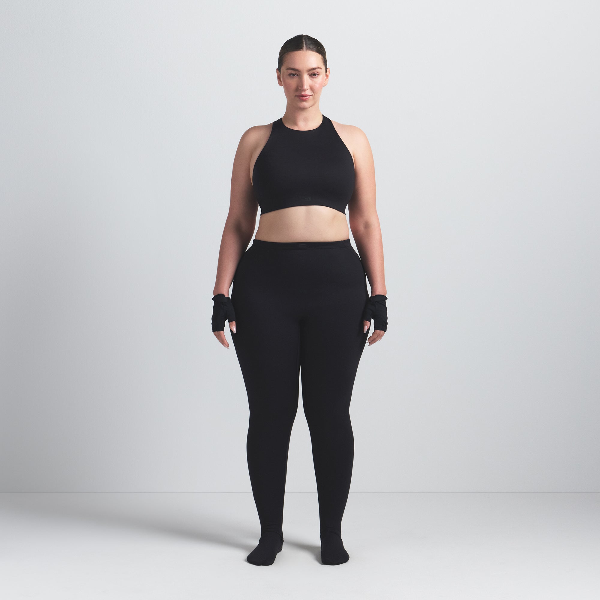 NikeSKIMS MATTE FOOTSIE GRIP LEGGING | OBSIDIAN ON A MODEL FRONT VIEW