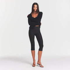 SKIMS BODY HIGH-WAISTED CAPRI | ONYX ON A MODEL FRONT VIEW @