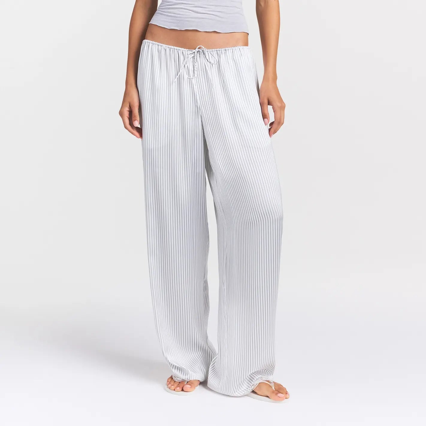 WOVEN SHINE LACE PANT | SILVER TRIPLE PINSTRIPE ON A MODEL SIDE VIEW @ | FOCUS: 0.0, 1.0, 0.9